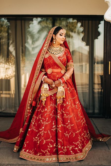 A bride dressed in red traditional lehenga