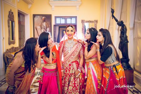 Photo of Bridesmaids blowing kisses to the bride