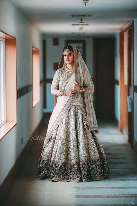 Photo of Gold sequin bridal lehenga with navy blue border