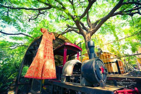 Photo of Bridal outfit on hanger on toy train engine