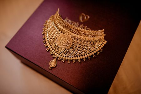 south indian bridal jewellery with gold necklace rose motif
