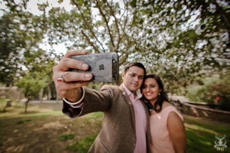 couple taking selfie pre wedding shoot