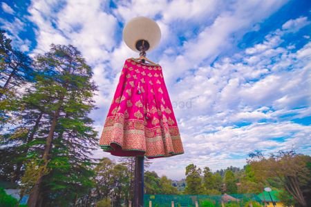 Bright pink and gold lehenga on lamp post outside