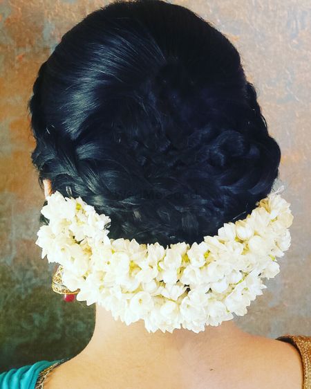 Low braided bun with gajra at the bottom