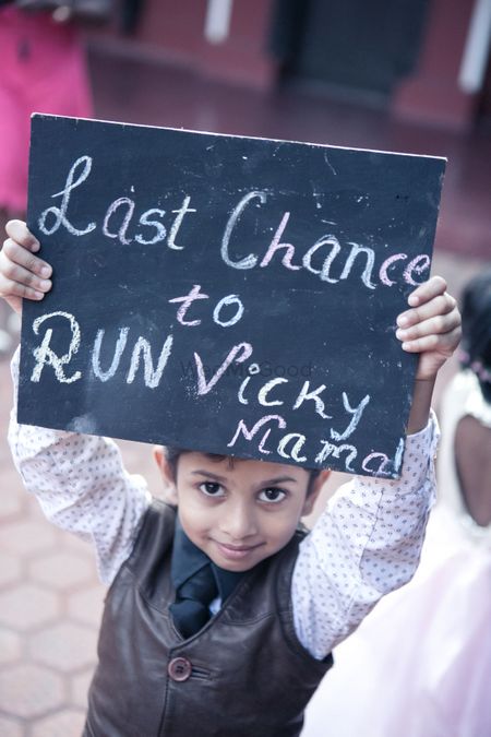 Kid holding placard with cute saying for bridal entry