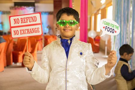 Kid holding fun placard during bridal entry
