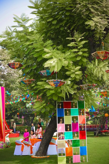 Colourful parasols and cloth decor on tree for mehendi