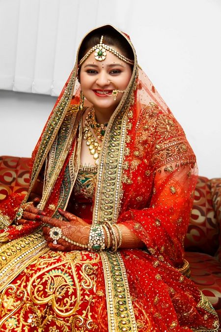Photo of Red and green bridal lehenga