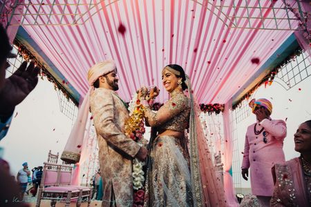 Photo of Coordinated bride and groom during jaimala
