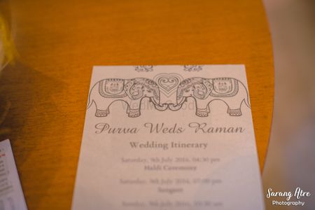 White wedding itinerary with elephant motifs