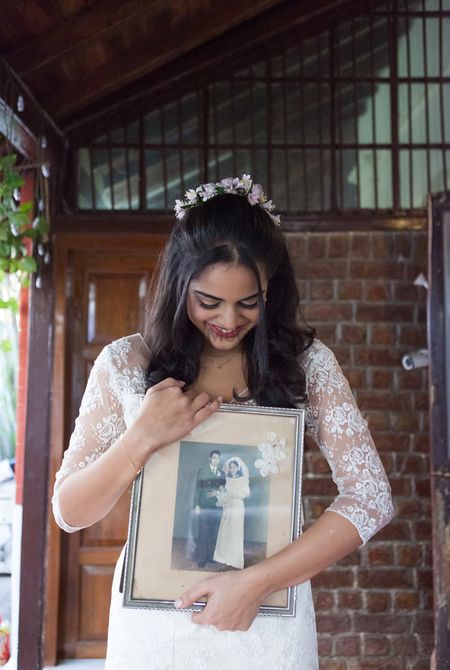 Click a photo holding the wedding photo of your mother and father