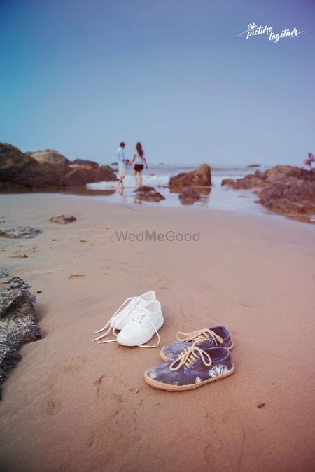 Beach pre wedding shoot with shoes on sand