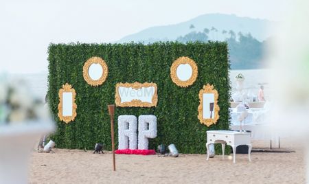 photo booth ideas with green grass backdrop and gold enamelled mirrors and RP Initials