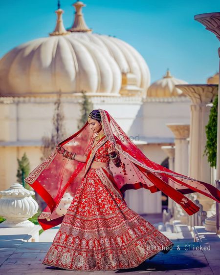 Photo of gold and red bridal lehenga with floral motifs