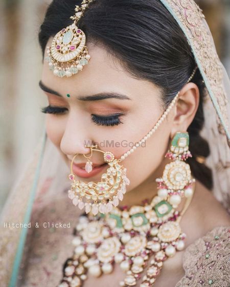 Photo of bridal jewellery with enamel work and unique nath