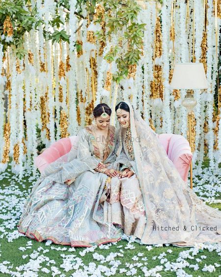 Photo of pretty bride with her sister with both wearing pastels