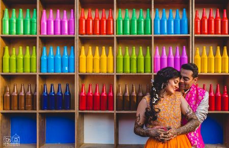 Photo of Colourful painted bottles as backdrop for mehendi