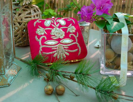 Photo of hot pink and gold bridal clutch with embroidery