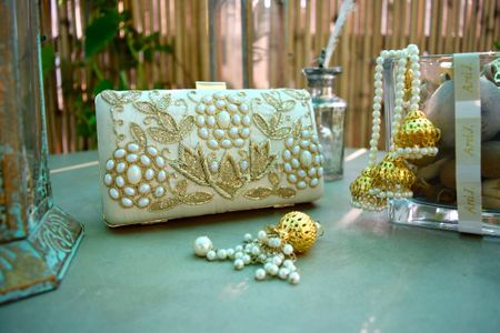 Photo of eggshell colored cream white box clutch with pearl and embroidery detailing