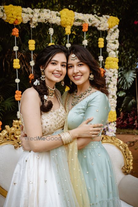 Photo of Bride posing with her sister.