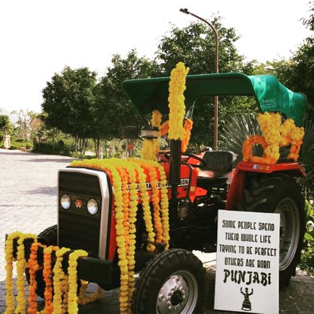 Photo of punjabi wedding decor with truck and funky signage board