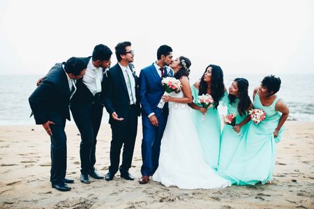 Photo of Couple on the beach with bridesmaids and groomsmen