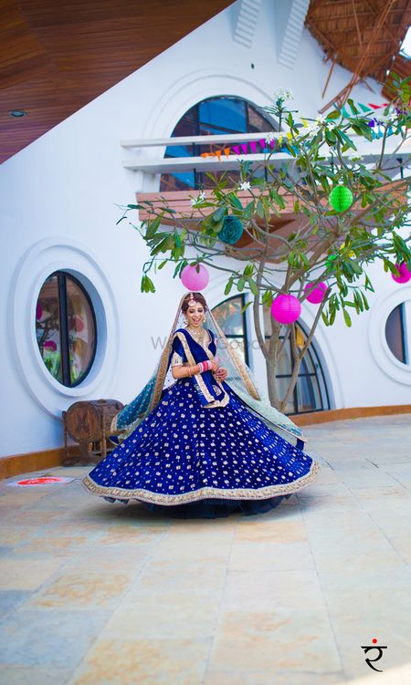 Offbeat bride in royal blue lehenga with gold motifs