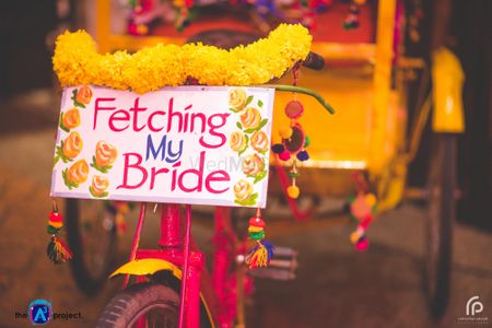 Mehendi decor idea with decorated rickshaw and quote