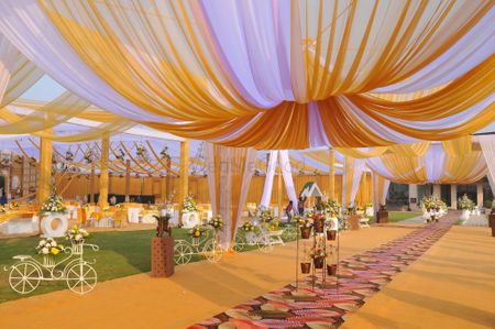 Photo of day wedding yellow and white canopy tents decor