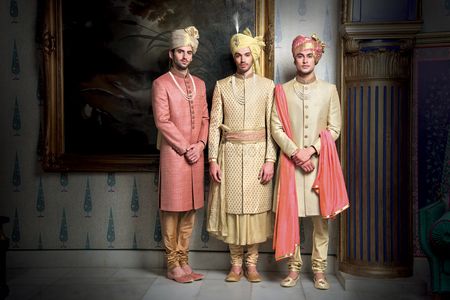 Dusty pink and gold sherwanis
