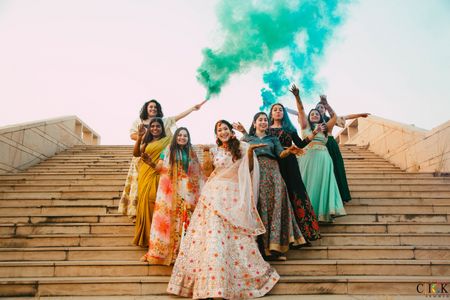 Bride with bridesmaids with smoke bombs