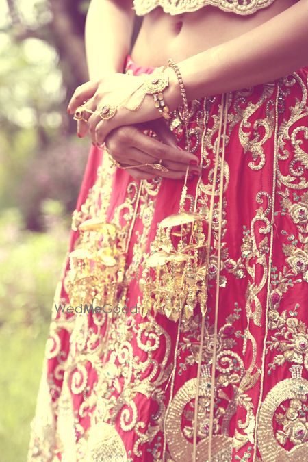 Photo of Gold kaleere with red bridal lehenga