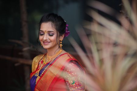 Photo of Marathi bride dressed in a red & blue saree.