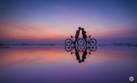 Photo of Pre wedding shoot with cycles on beach during sunset