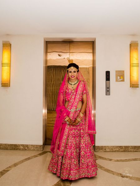Bright pink bridal lehenga with floral embroidery 