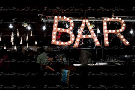 Photo of Hanging bar sign with bulbs