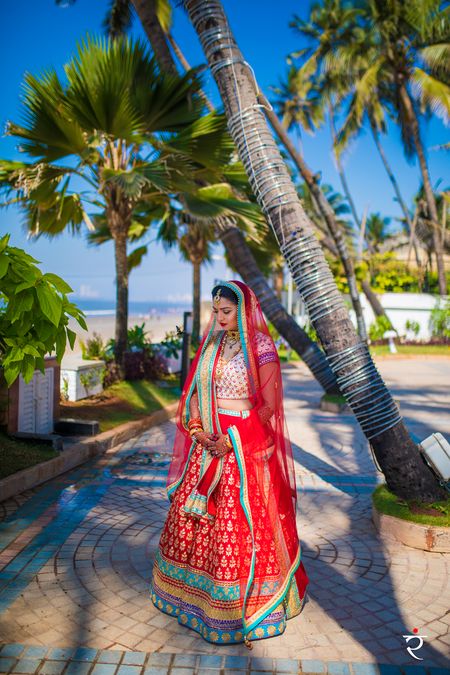 Offbeat bridal lehenga in red with turquoise border and white blouse