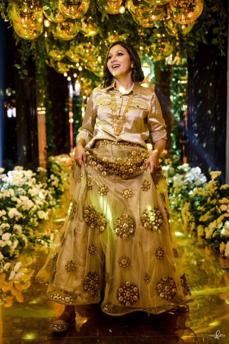 Bride wearing a satin shirt with an embellished skirt.