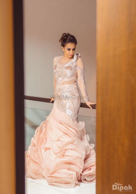 Ruffled peach full-sleeved gown with silver work
