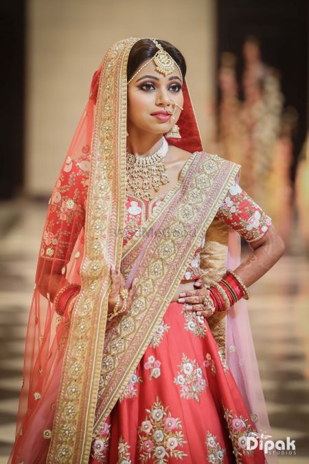 Embellished floral bridal lehenga in coral and lilac combination
