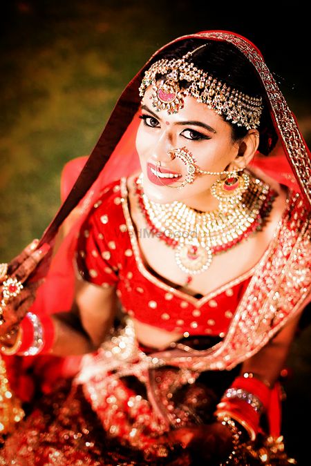 Photo of Bridal jewellery with mathapatti nath and choker necklace with red beads