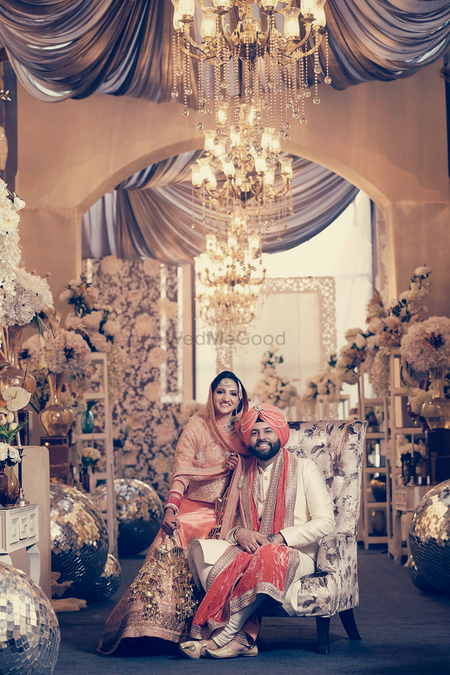 Photo of chandeliers and floral sikh wedding decor