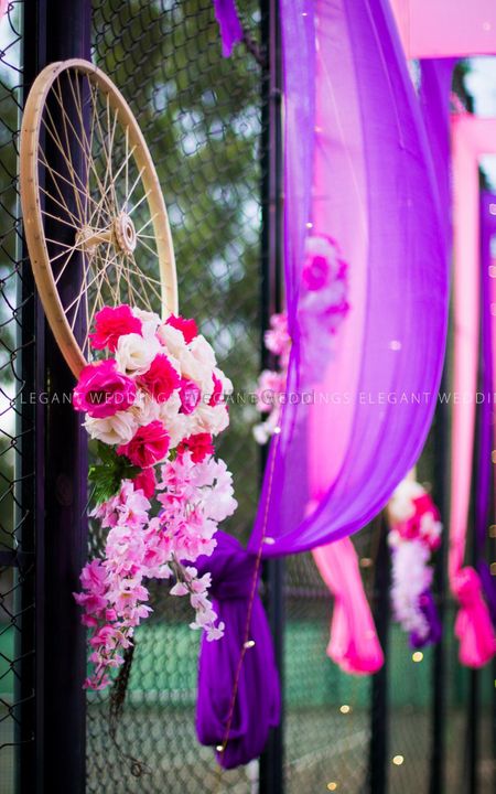 Photo of Cycle wheel prop with flowers and pink and purple theme