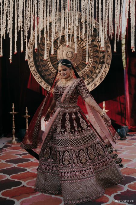 Photo of Bride twirling around in her velvet lehenga.