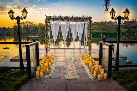 A simple floral and candle decor for proposal by the water