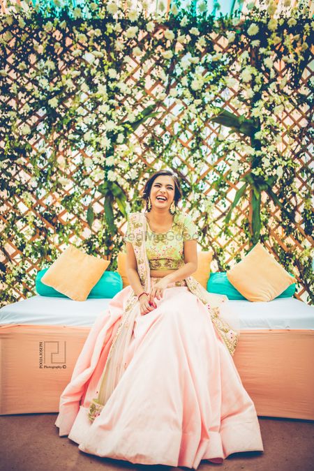 Photo of Laughing bride shot in pastel lehenga for mehendi