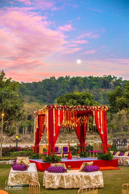 Red and purple theme outdoor mandap decor in the hills
