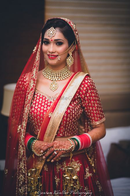 Photo of Red bridal lehenga with double dupatta draping