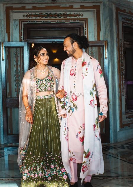 cute bride and groom mehendi outfits with florals