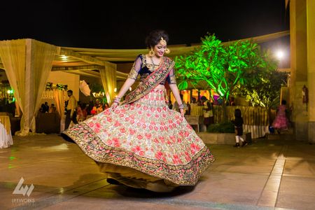 Photo of Twirling bride shot wearing floral embroidery lehenga